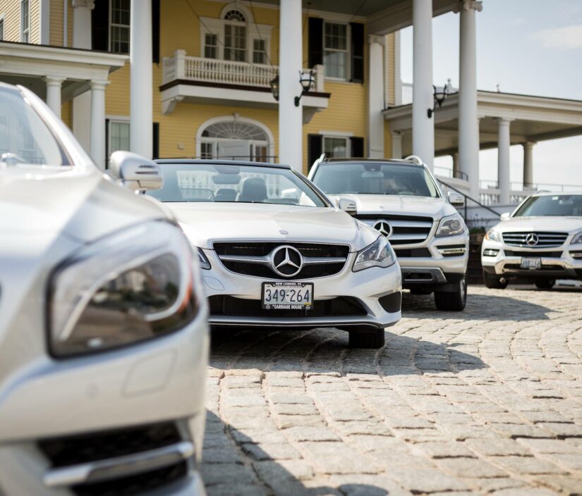 Four cars parked in front of Ocean House Hotel.