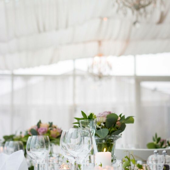 A wedding venue with a set dining table.