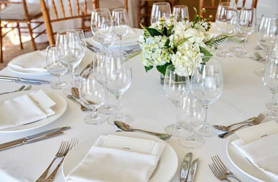 A set dining table with flowers.