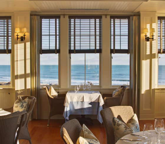 An indoor dining area with an ocean view.