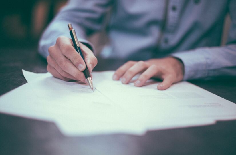 A person writing on a document.