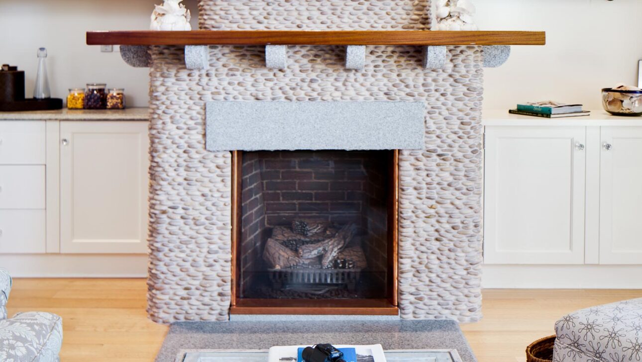 A coffee table and fireplace in the Block Island Suite.