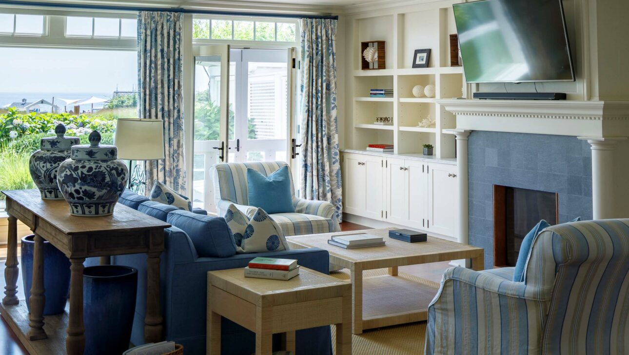 Blue Skies Suite living room with blue seats, a coffee table, and a fireplace.