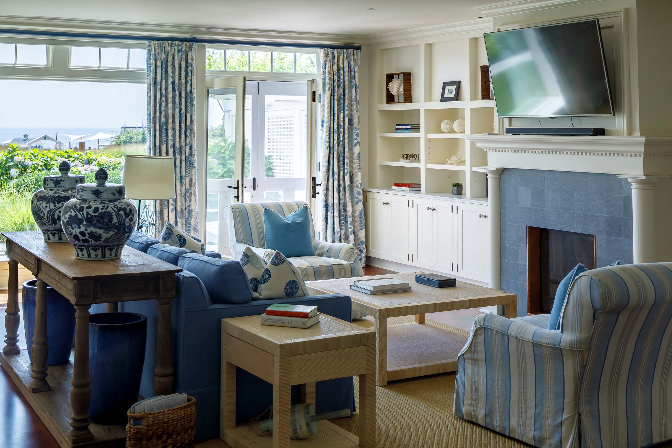 Blue Skies Suite living room with blue seats, a coffee table, and a fireplace.