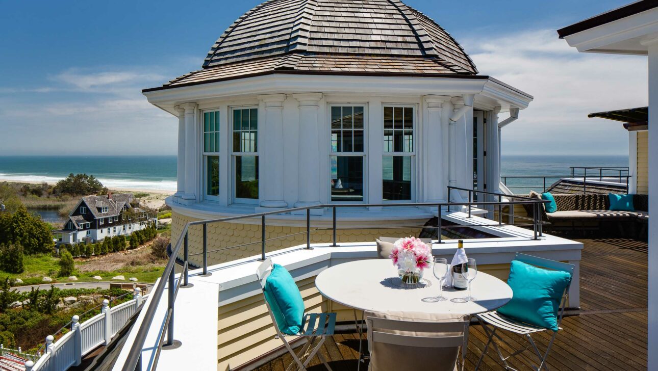 Carousel Suite veranda with a dining table and ocean view.