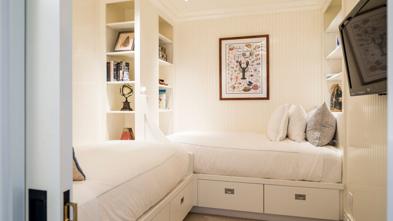 A bedroom with two beds in the Hydrangea Suite.