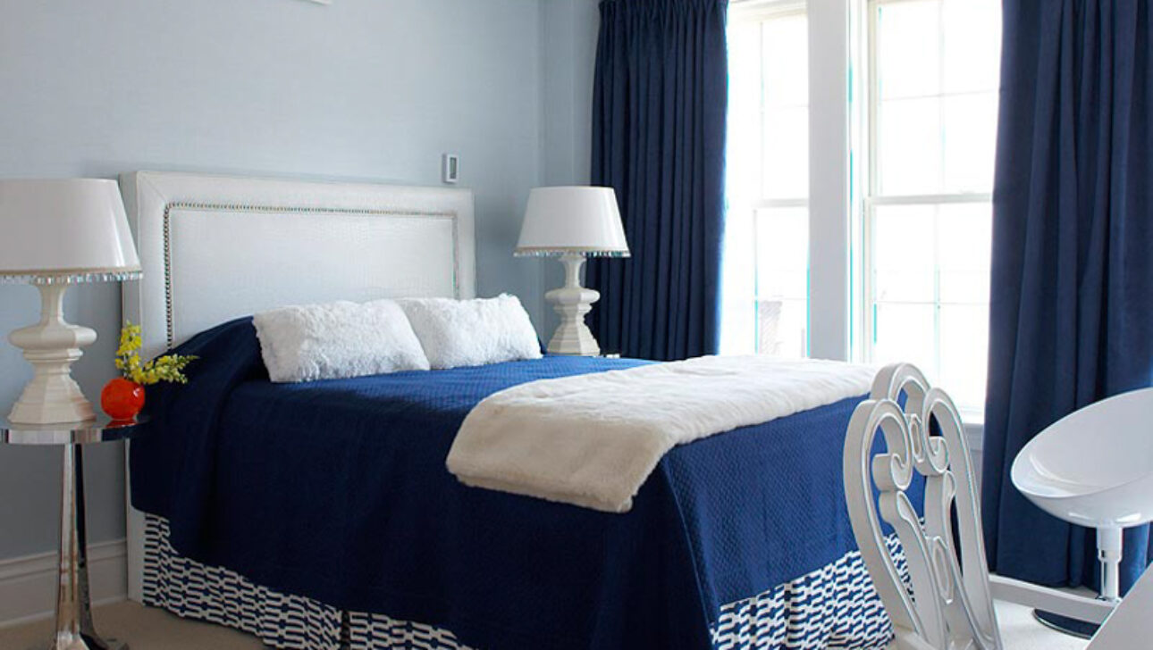 Lighthouse Suite bedroom with blue and white bedding.