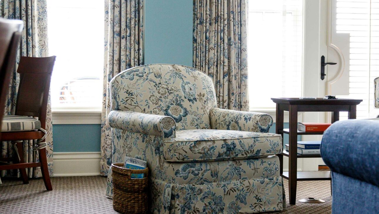 A blue and white loveseat in an Ocean View Terrace Suite.