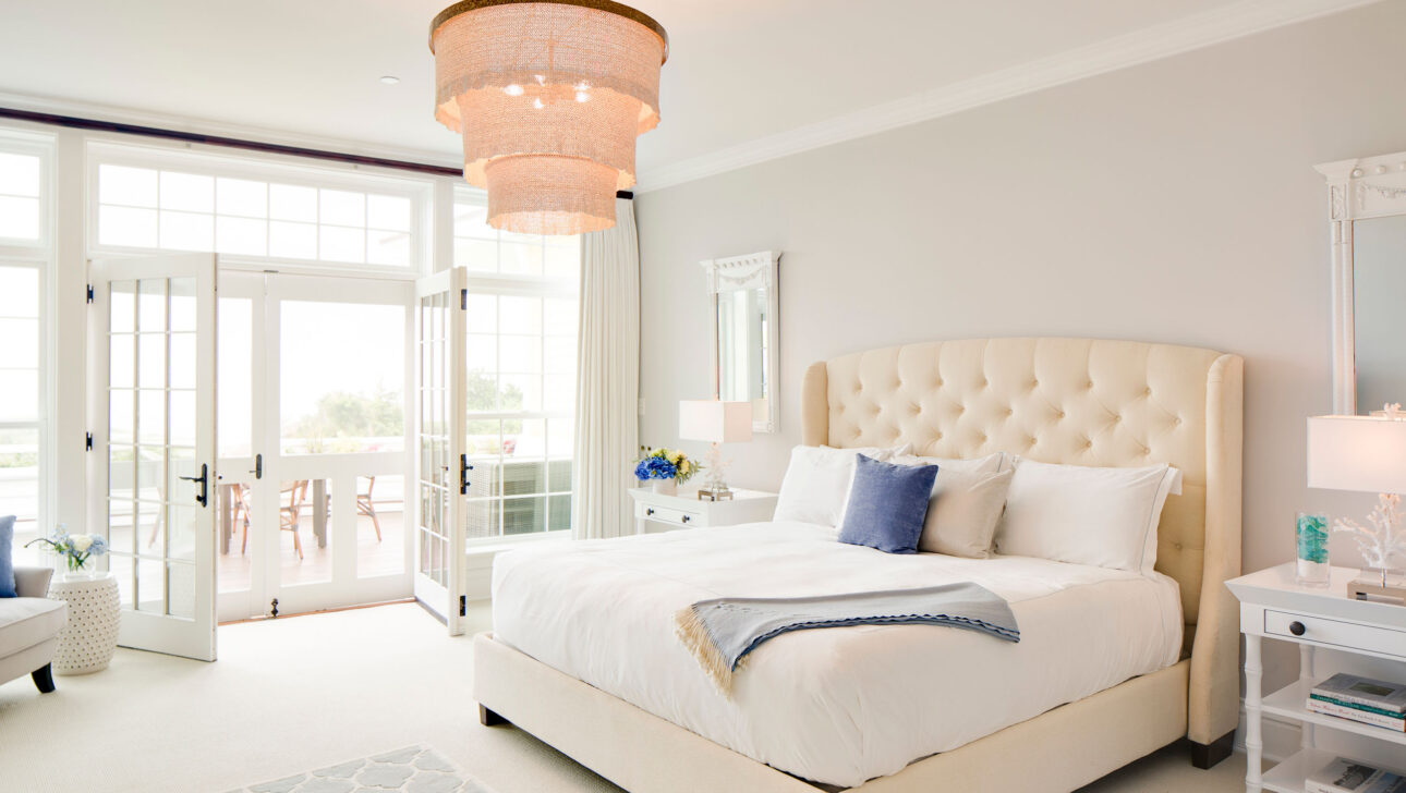 Sea Glass Suite bedroom leading to an outdoor patio.