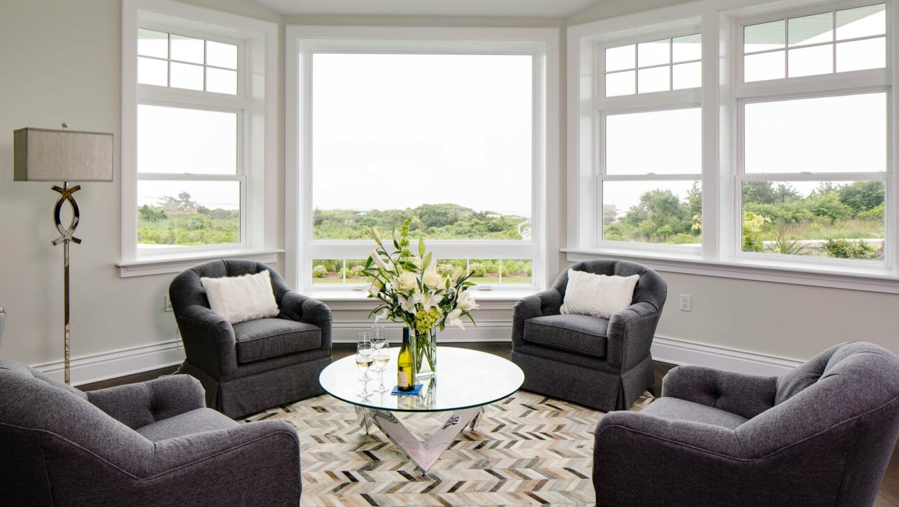 Sea Glass Suite lounge area with four seats and a round coffee table.