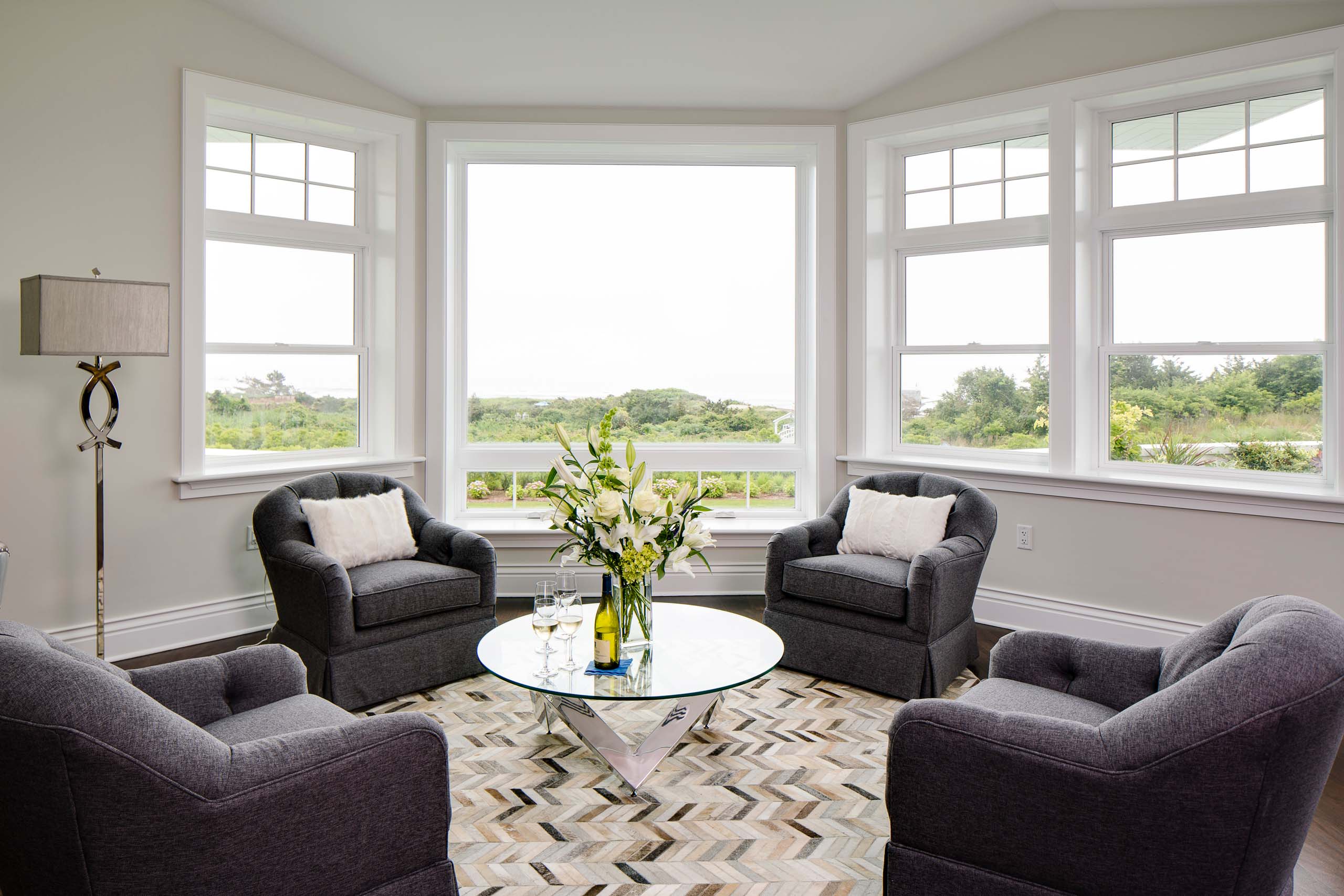 Sea Glass Suite lounge area with four seats and a round coffee table.