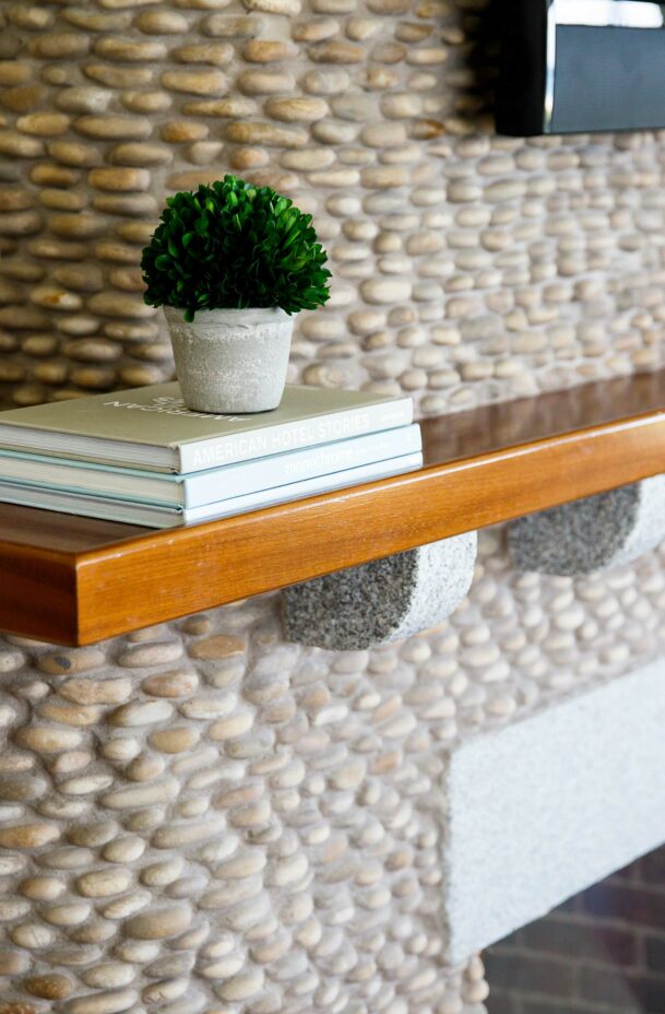 A shelf with a small stack of books.