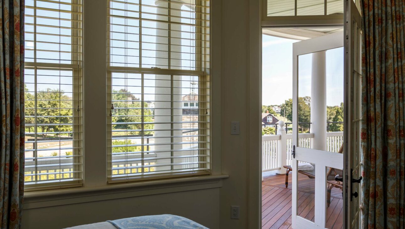 A Weekapaug Suite bedroom leading to a veranda.