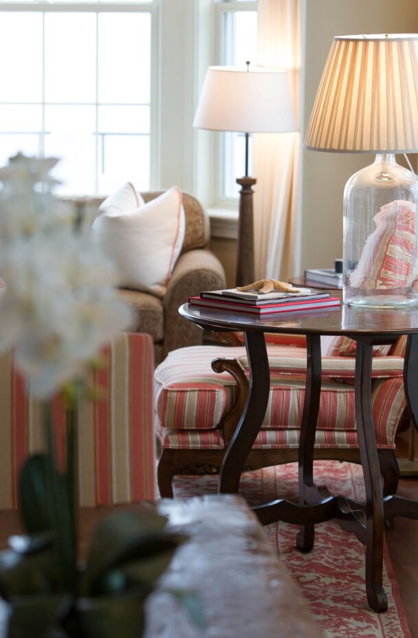 Narragansett Suite side table in the living room with a lamp and books.