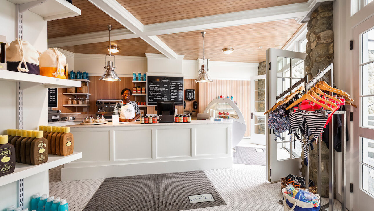 A woman standing behind the counter of Below Deck.