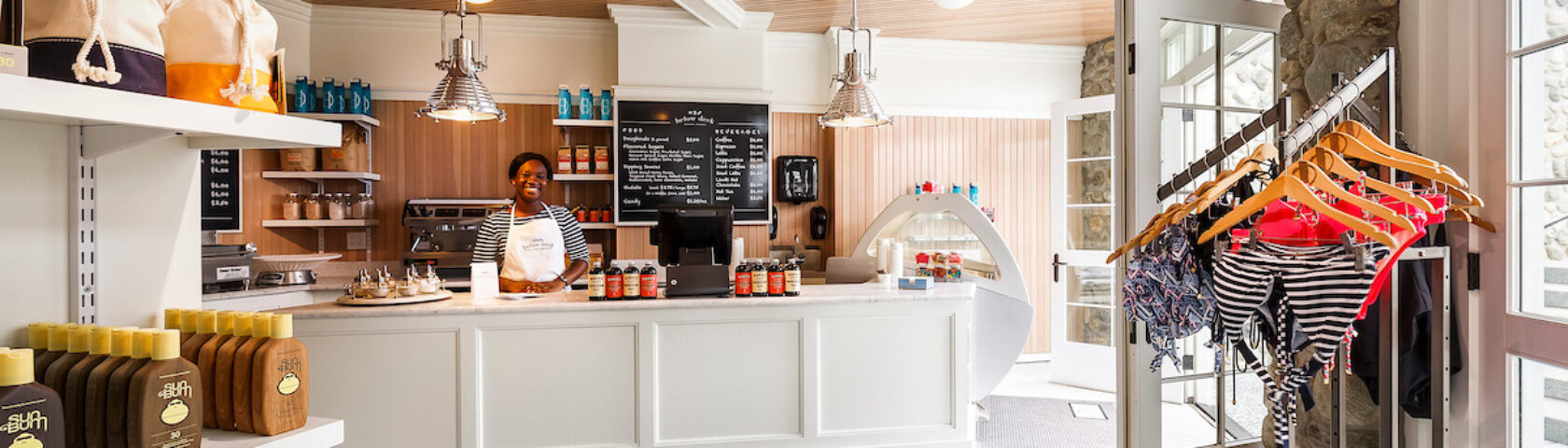 A woman standing behind the counter of Below Deck.