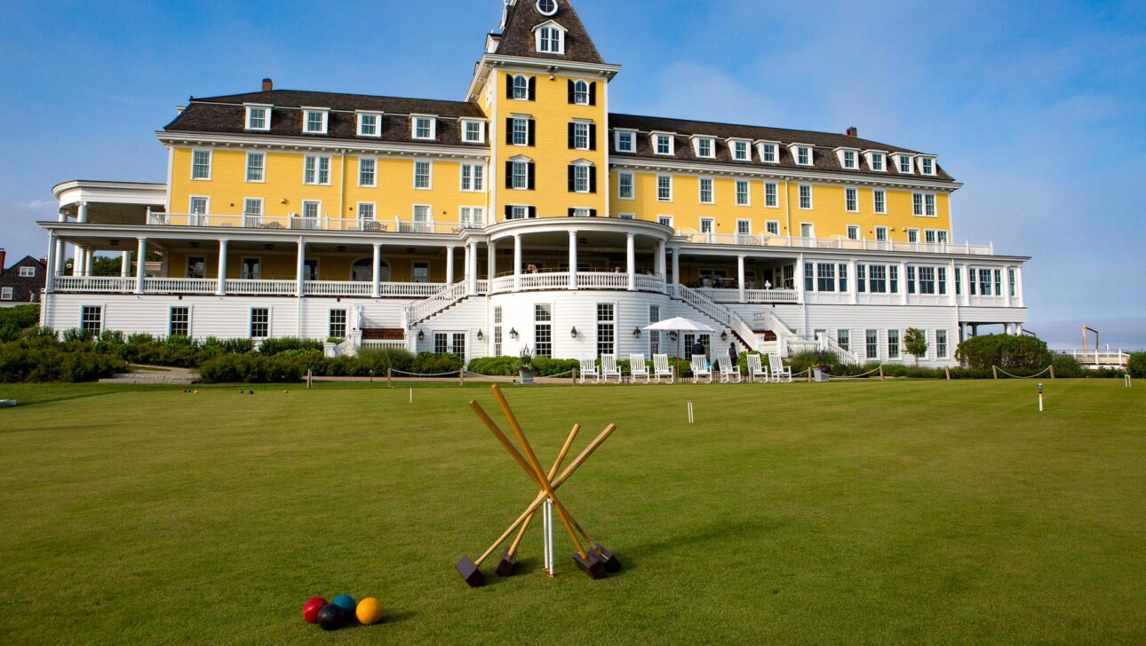 Croquet mallets and balls with Ocean House Hotel in the background.