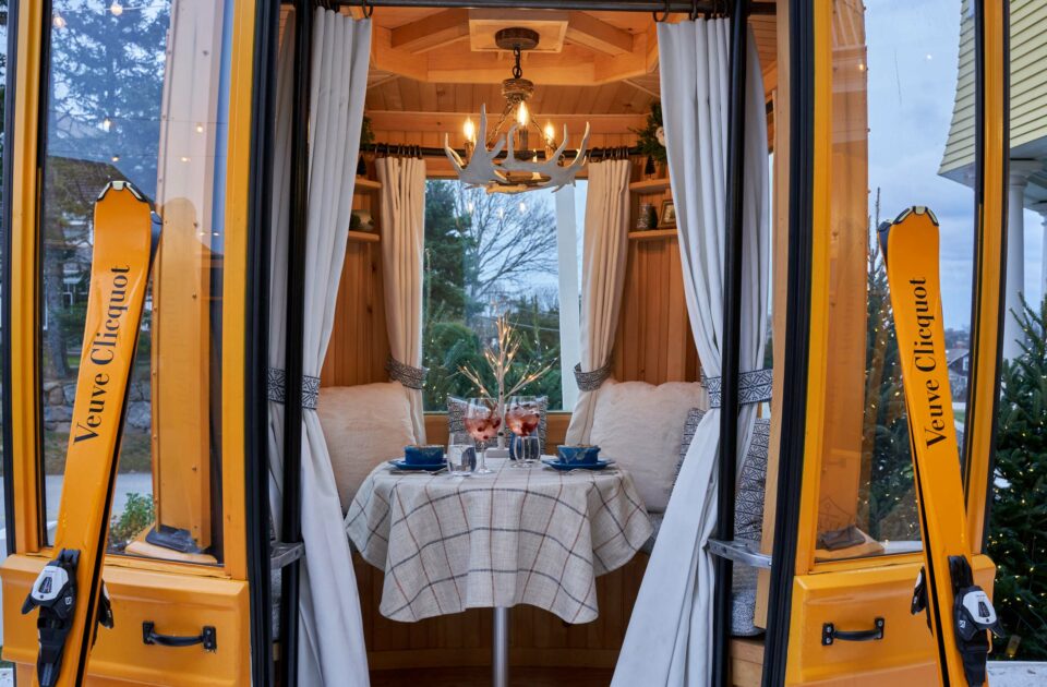 A gondola with a set dining table inside.