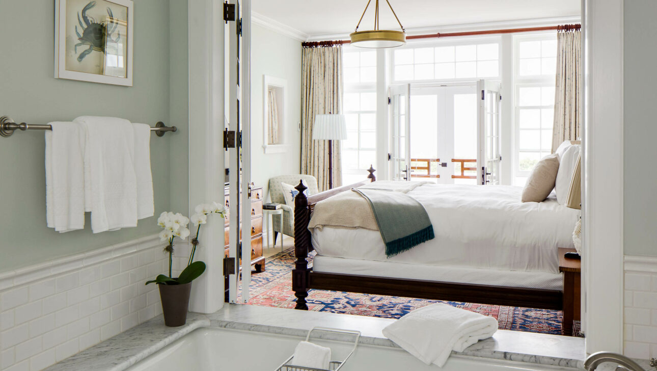 Morgan Suite bedroom next to an open bath tub.