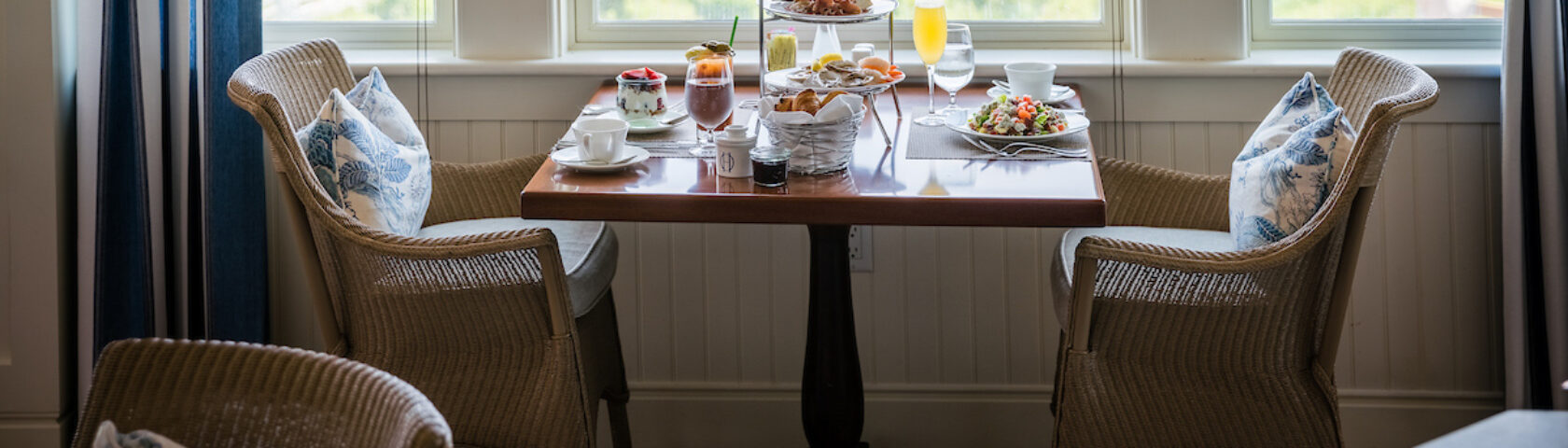 A set dining table near a window for Sunday Jazz Brunch.