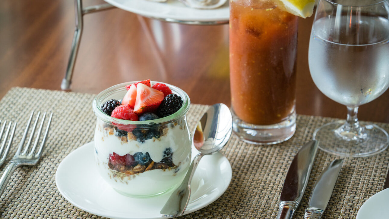 A cup of granola, yogurt, and berries.