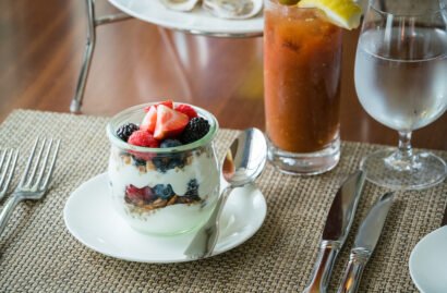 A cup of granola, yogurt, and berries.