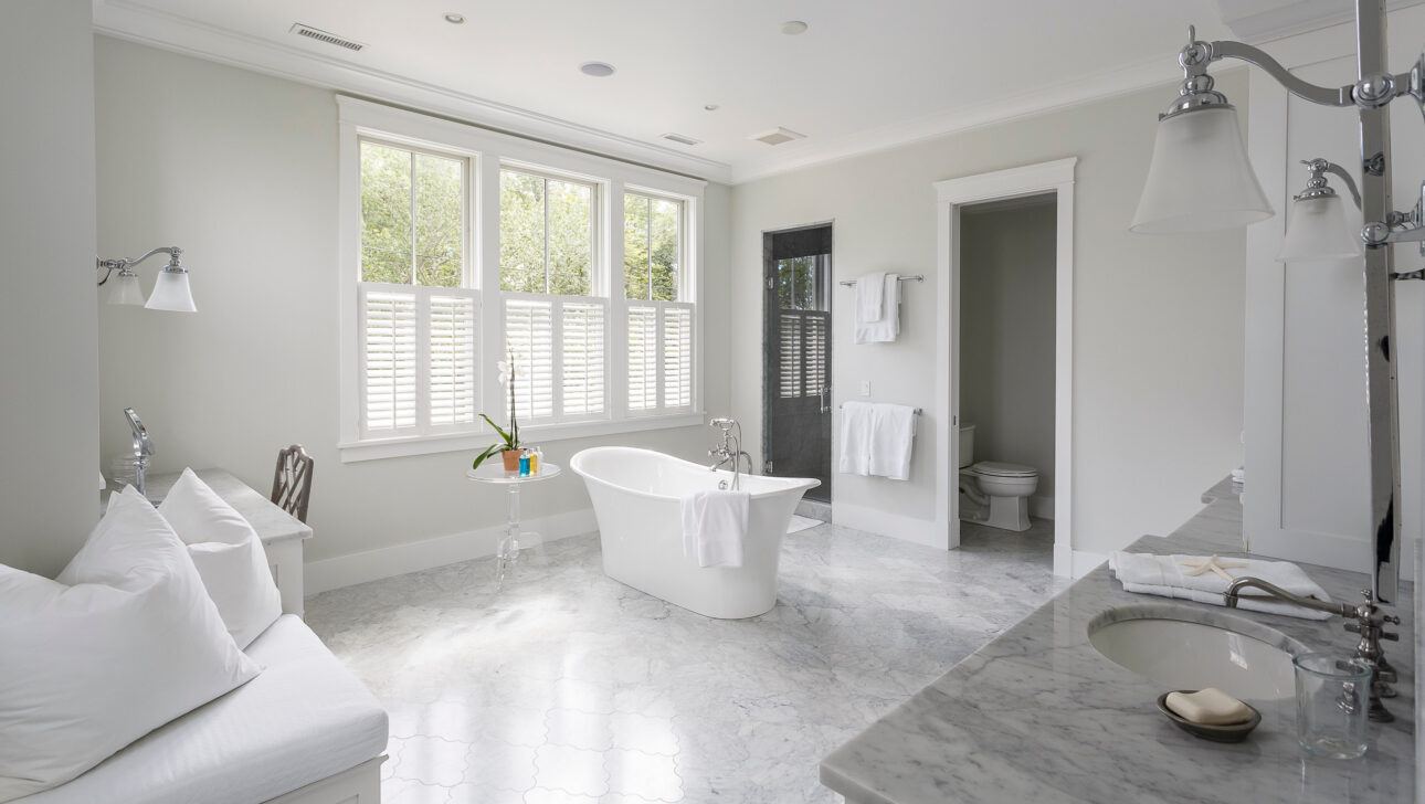 Sunset Cove bathroom with white interiors and a bath tub.