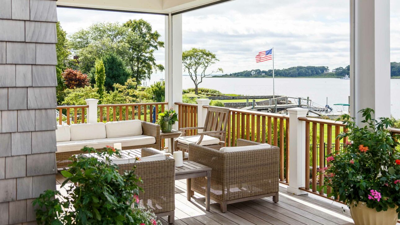 Sunset Cove porch with seats and a table.