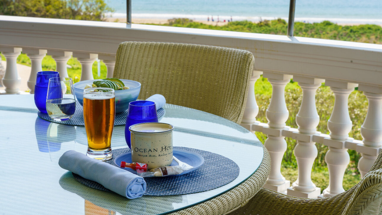 An outdoor dining table set with a bowl of clam chowder at the Verandah Raw Bar.