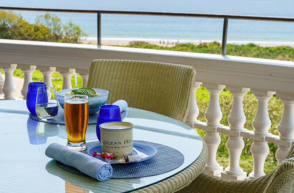 An outdoor dining table set with a bowl of clam chowder at the Verandah Raw Bar.